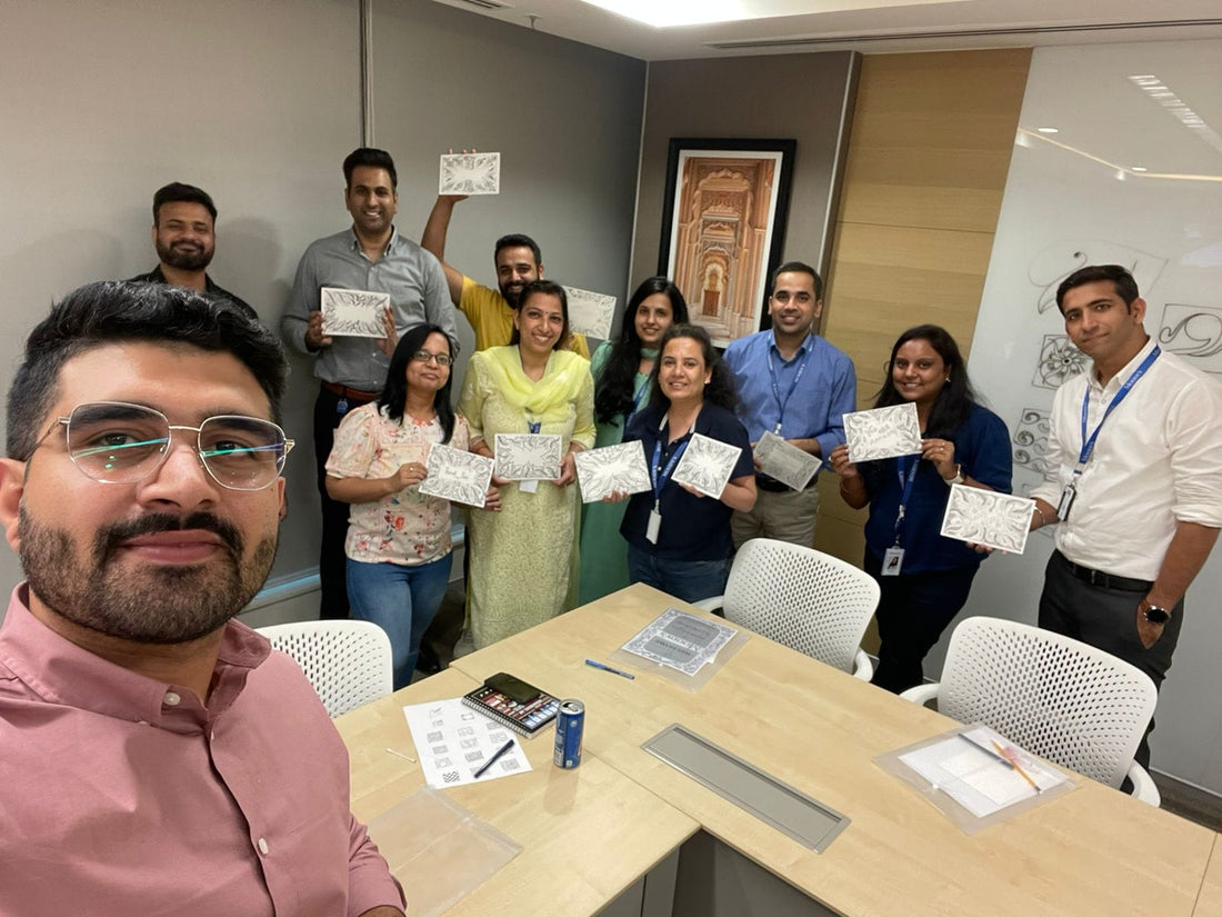 Employees participating in a corporate mandala art workshop, creating colorful mandala designs together in a team-building session