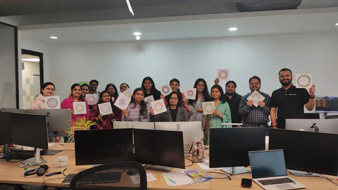 Employees engaging in Mandala art activities in a corporate setting to promote creativity, relaxation, and mindfulness.