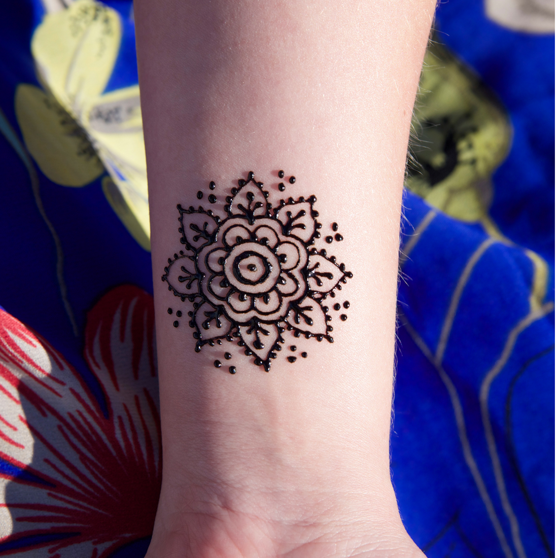 Intricate mandala tattoo design featuring symmetrical geometric and floral patterns symbolizing spirituality and balance.