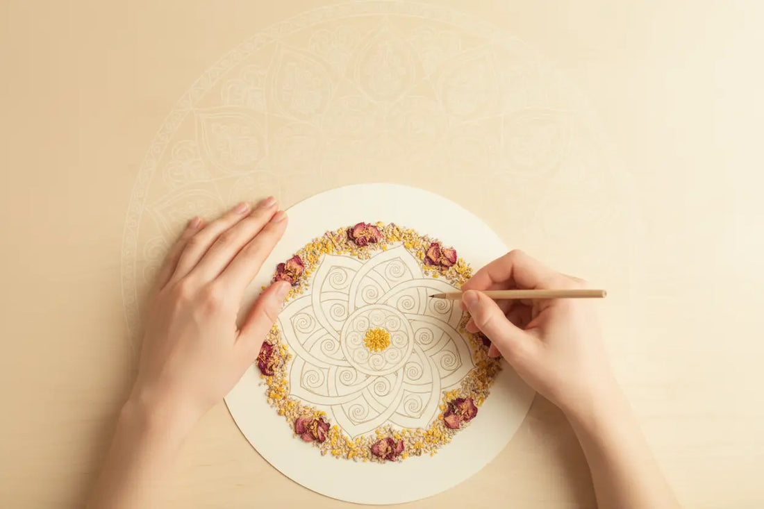 Hands coloring the mandala design.