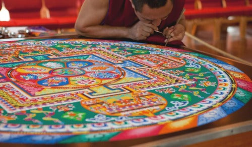 A person engaged in designing mandala.